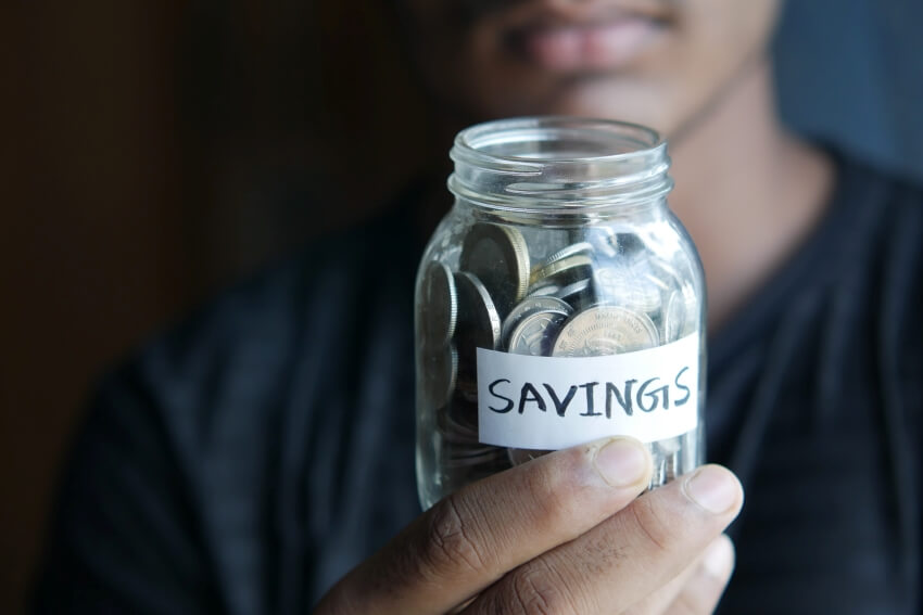 Man Holding a Savings Jar
