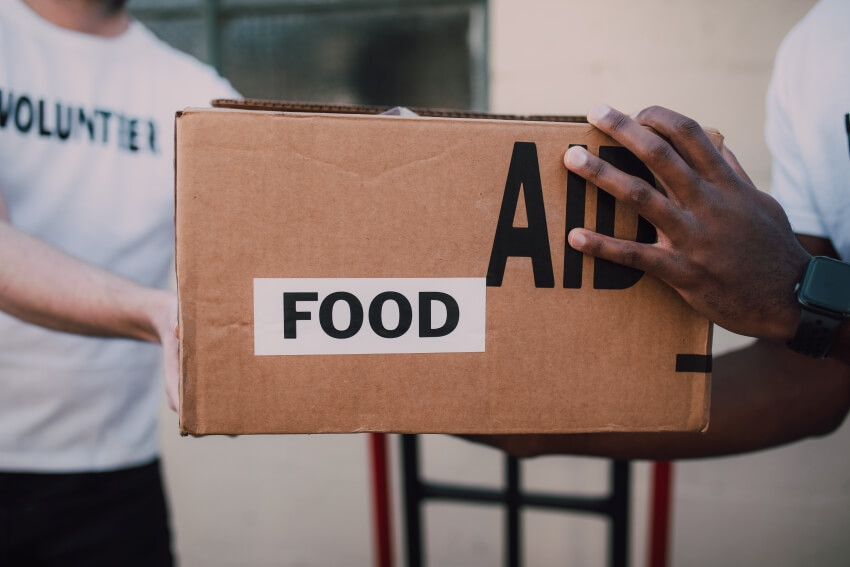 Volunteer Giving Food Aid