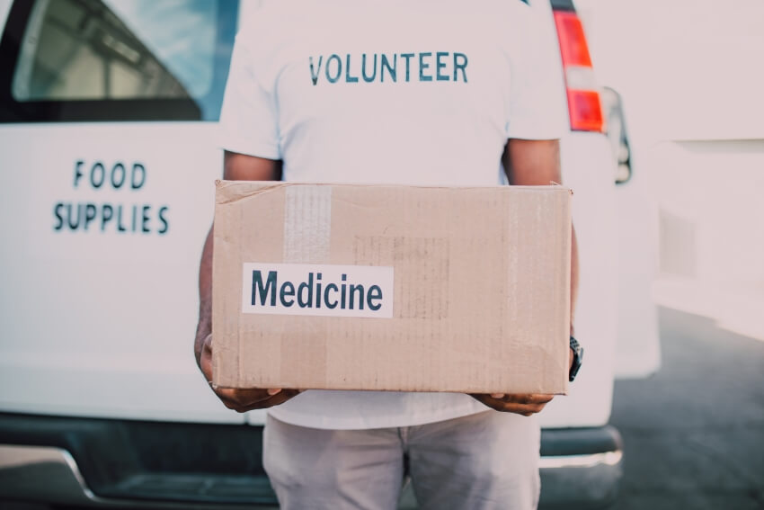 Volunteer Holding a Medicine Box