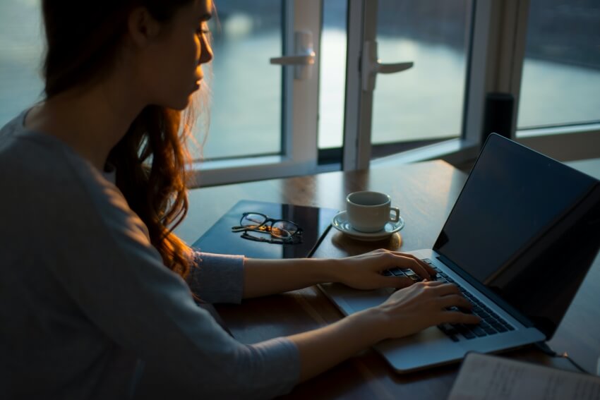 Woman Working with a Cup of Coffee