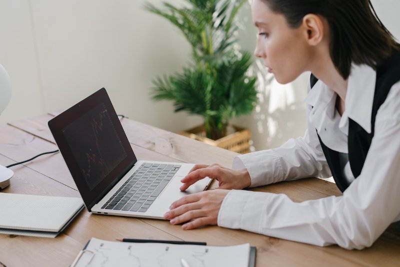 Woman Looking at a Chart on Laptop