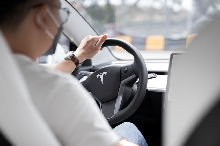 Man Wearing a Mask While Driving a Car