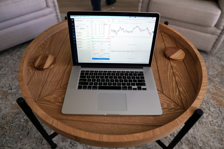 Laptop on a table Showing Stock Market Chart