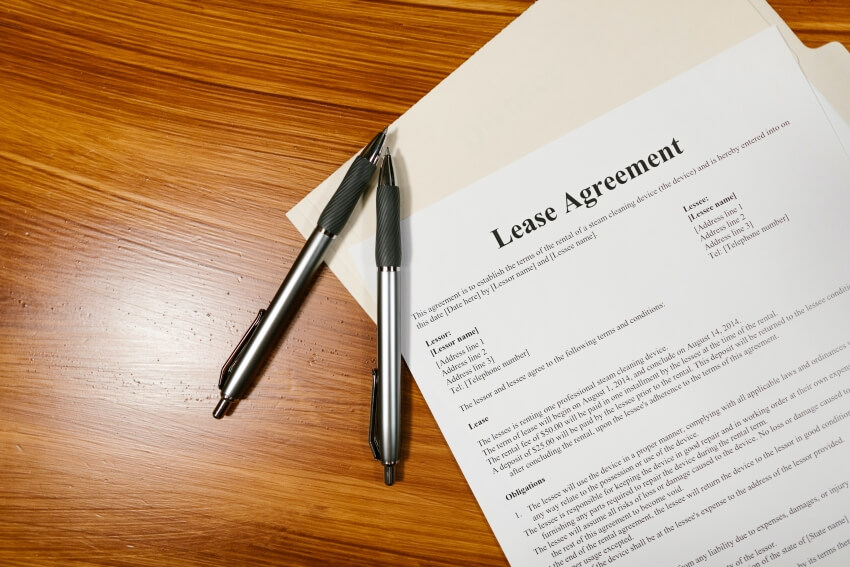 Two Pens and a Lease Agreement Form