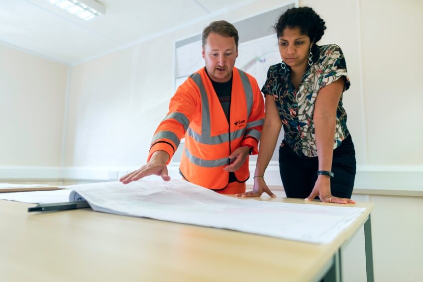 Man and Woman Looking a  Plan