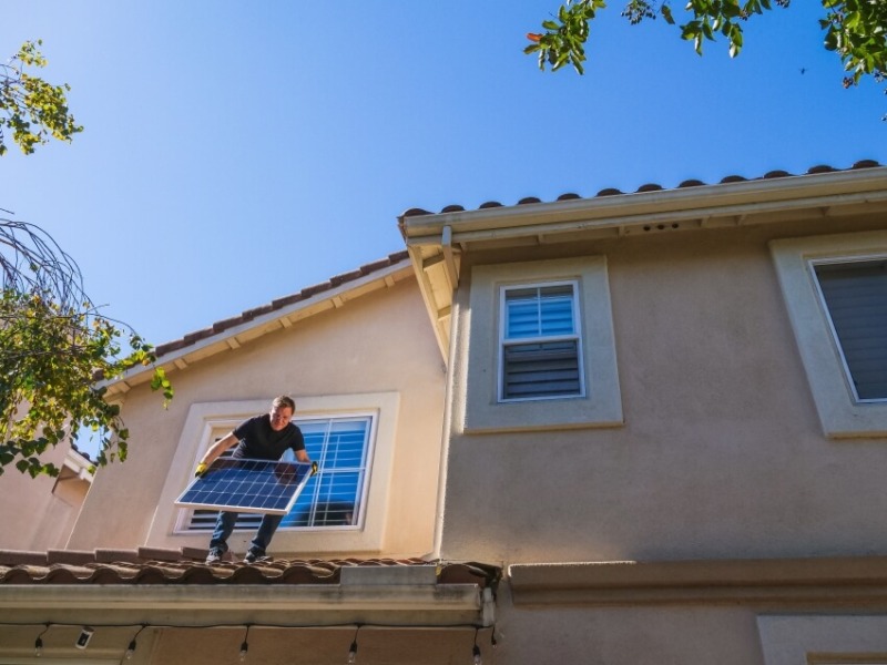 Man Installing a Piece of Solar Panel