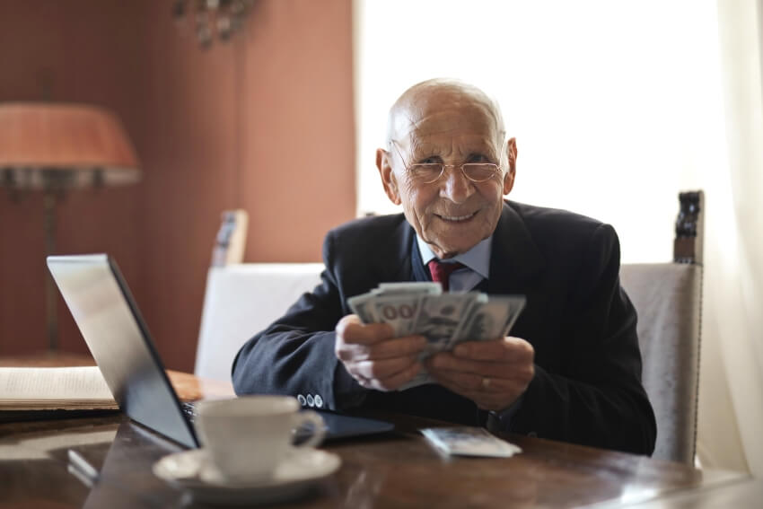 Old Man Holding Paper Bills