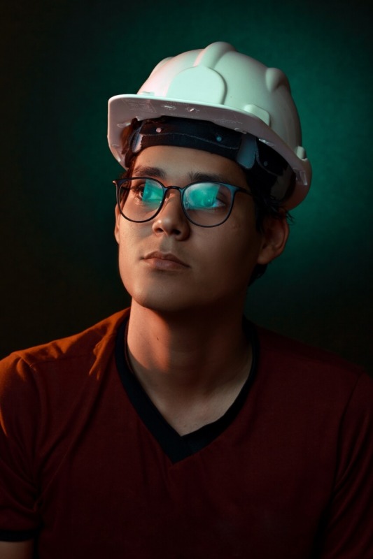 Man Wearing Glasses and a White Safety Hard Hat