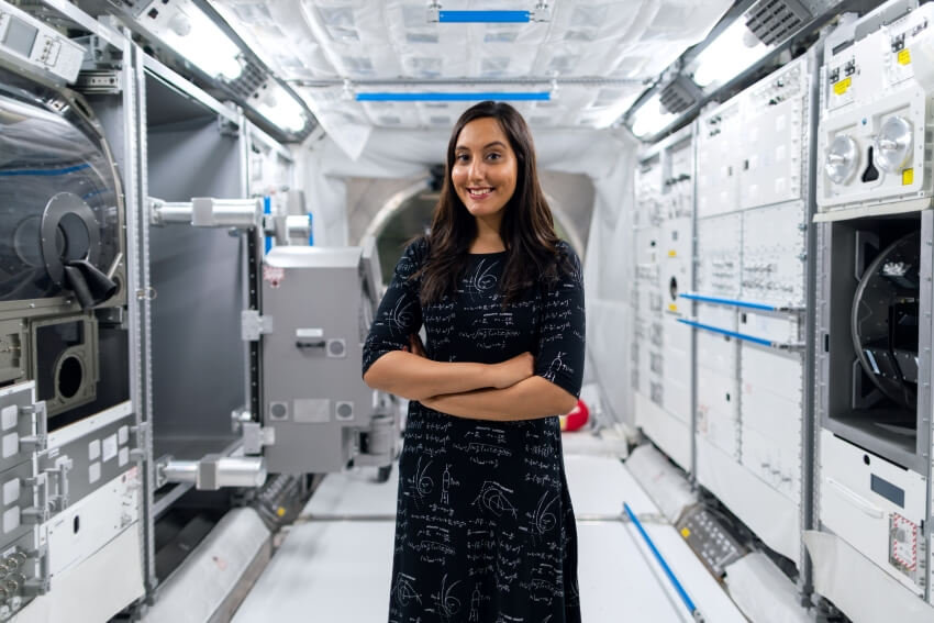 Woman Smiling inside an Aerospace Station