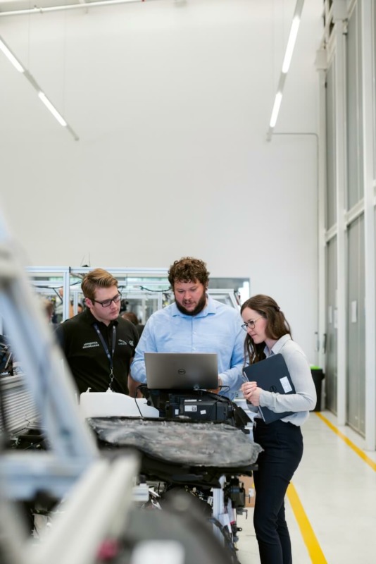 Group of Workers Looking on a Laptop