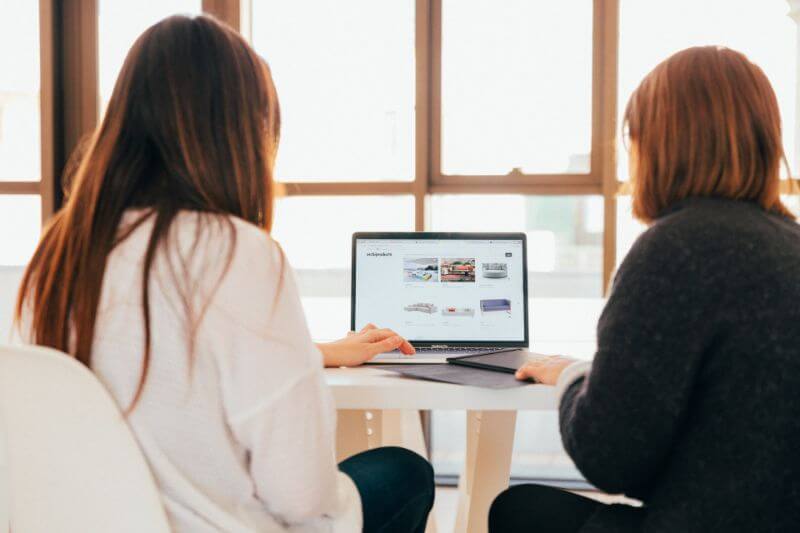 Two girl looking at the screen