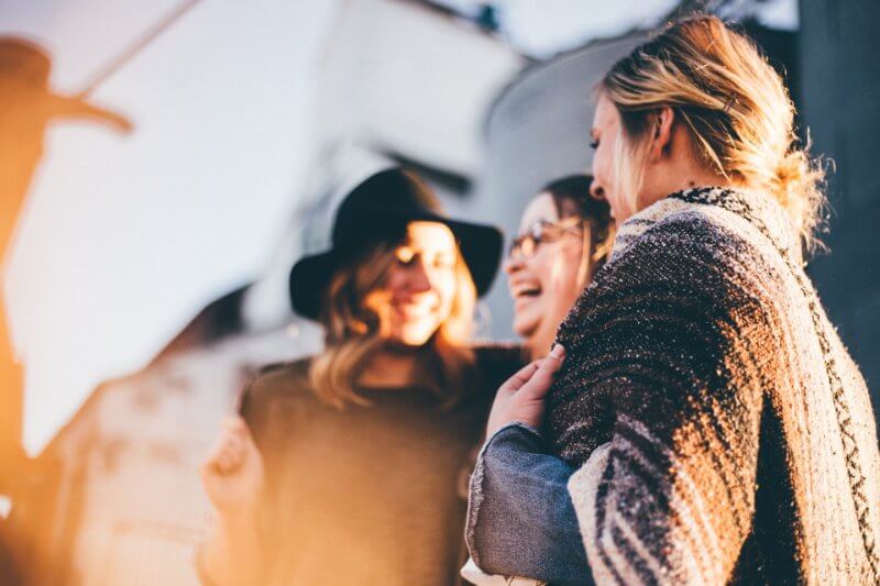 A group of girls gathering and laughing, social entrepreneurship