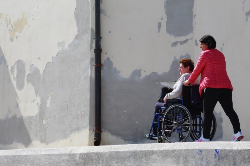 Caregiver Helping an Old Woman