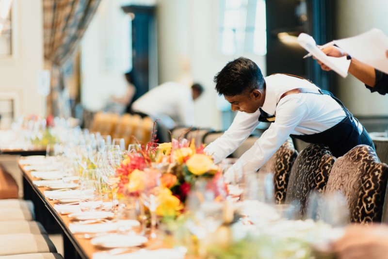 Restaurant Waitstaff Preparing a Table