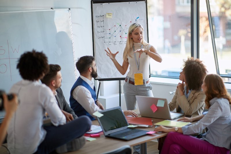 Business woman present her idea to working team