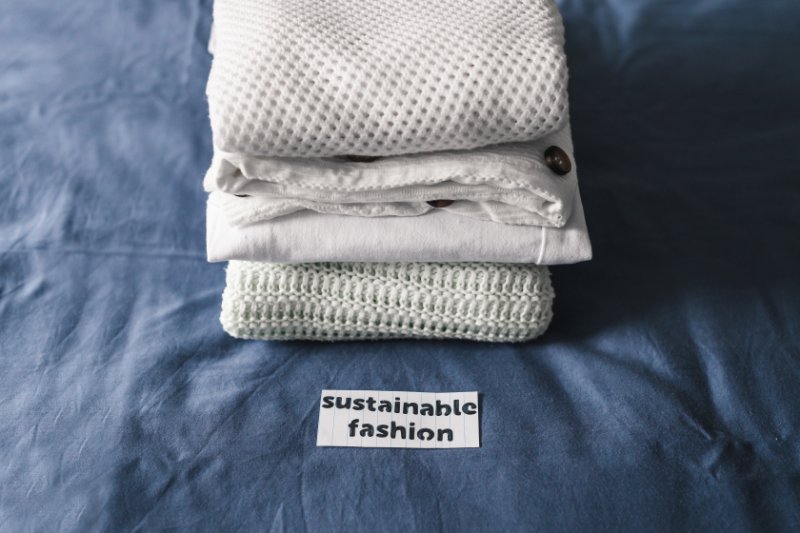pile of clothing with Sustainable Fashion label