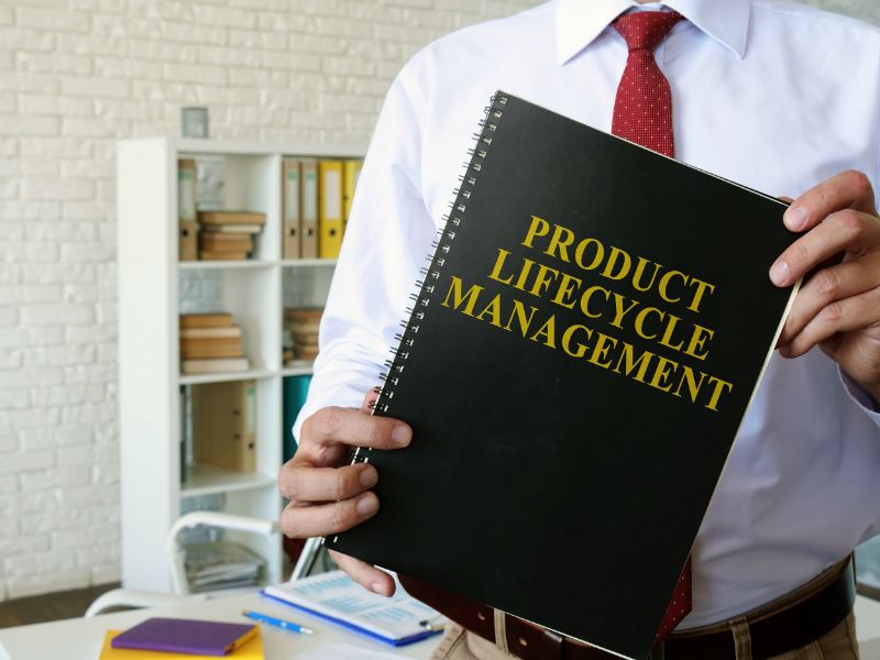 Man Holding a Product Lifecycle Management Book