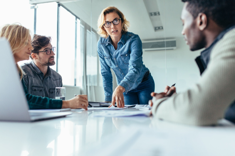 Female executive putting her ideas during presentation in conference room.