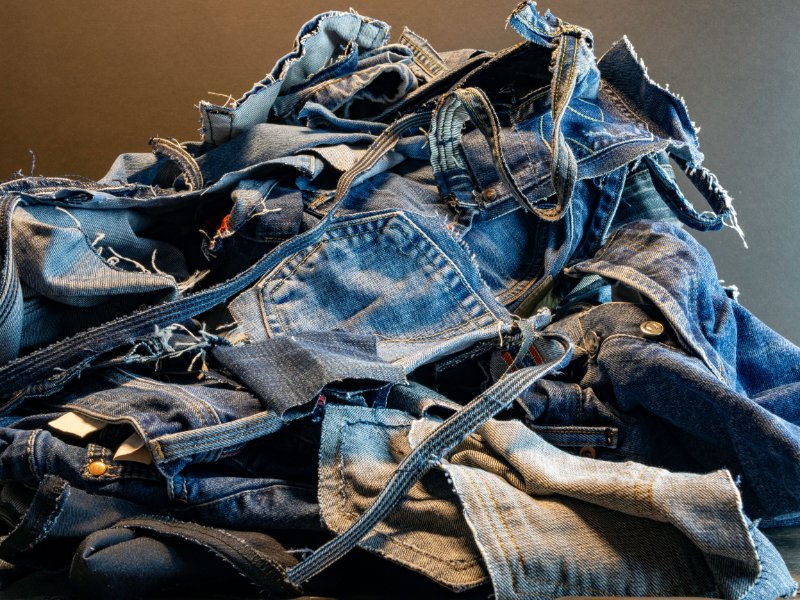 Pile of old blue jeans ready for recycling