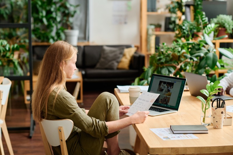 Young creative business woman working and looking on the laptop