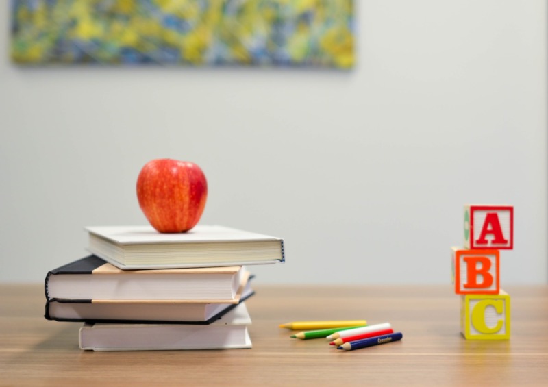 Apple on the top of books and ABC Wood blocks