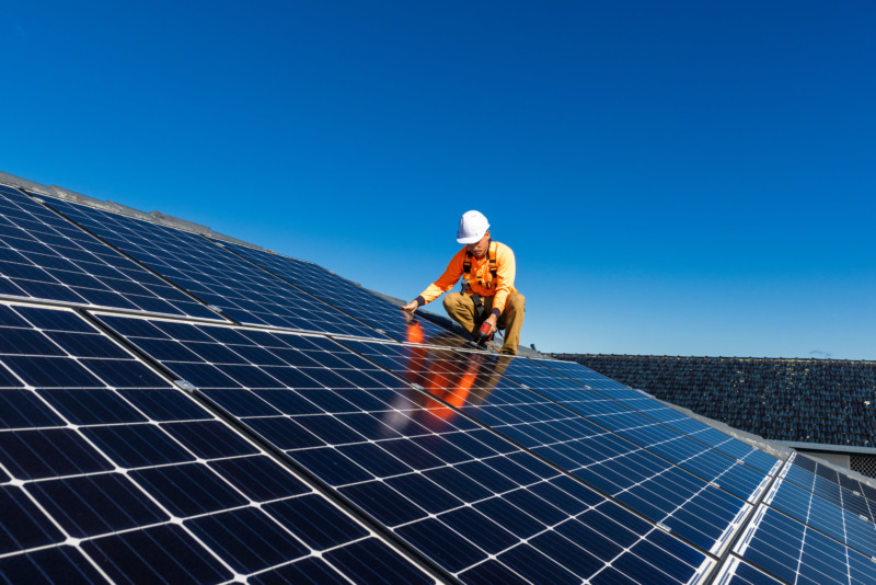 Technician installing solar panels