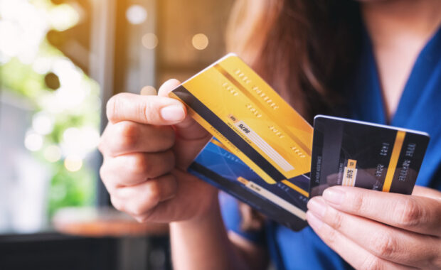 Woman holding three credit cards