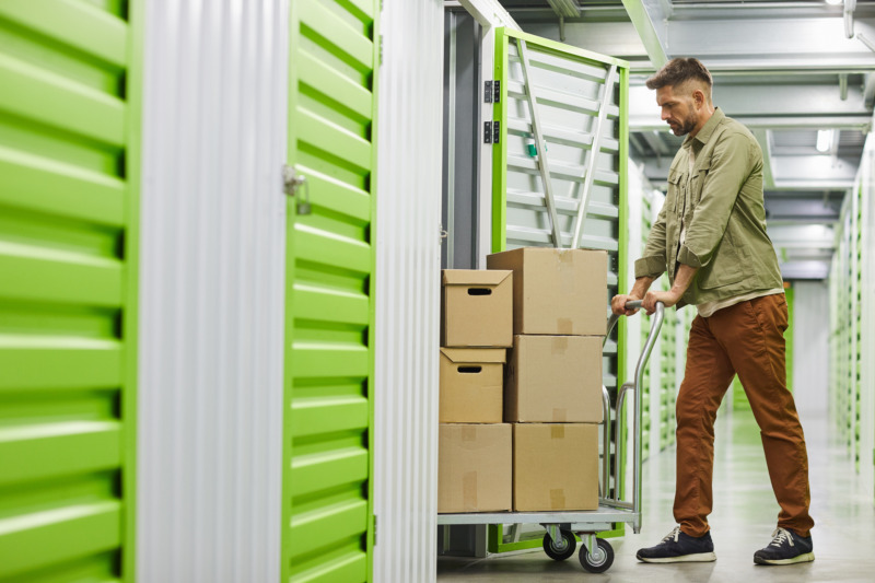 Man putting boxes on Self Storage Unit