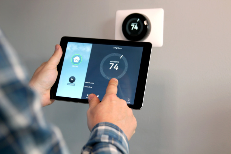 Man Controlling the Smart Home Thermostat