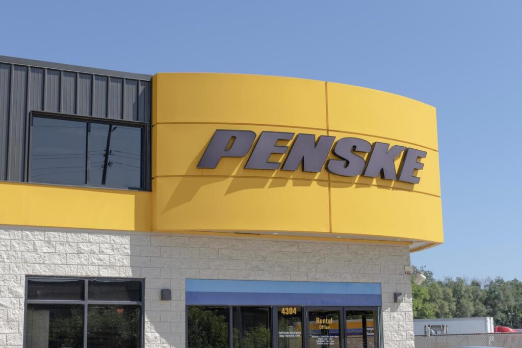 Penske rental office exterior with company sign under blue sky, truck leasing services.