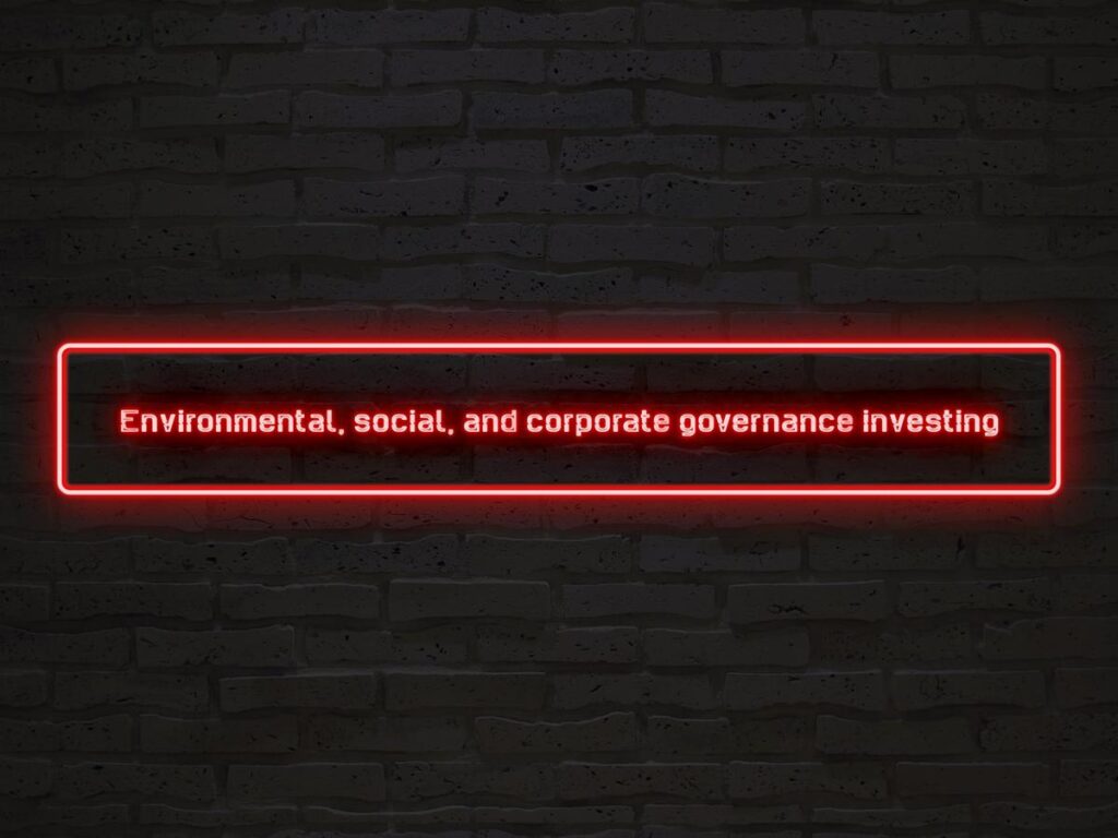 Neon sign on brick wall showcasing ESG investing for sustainable finance and responsible investing.